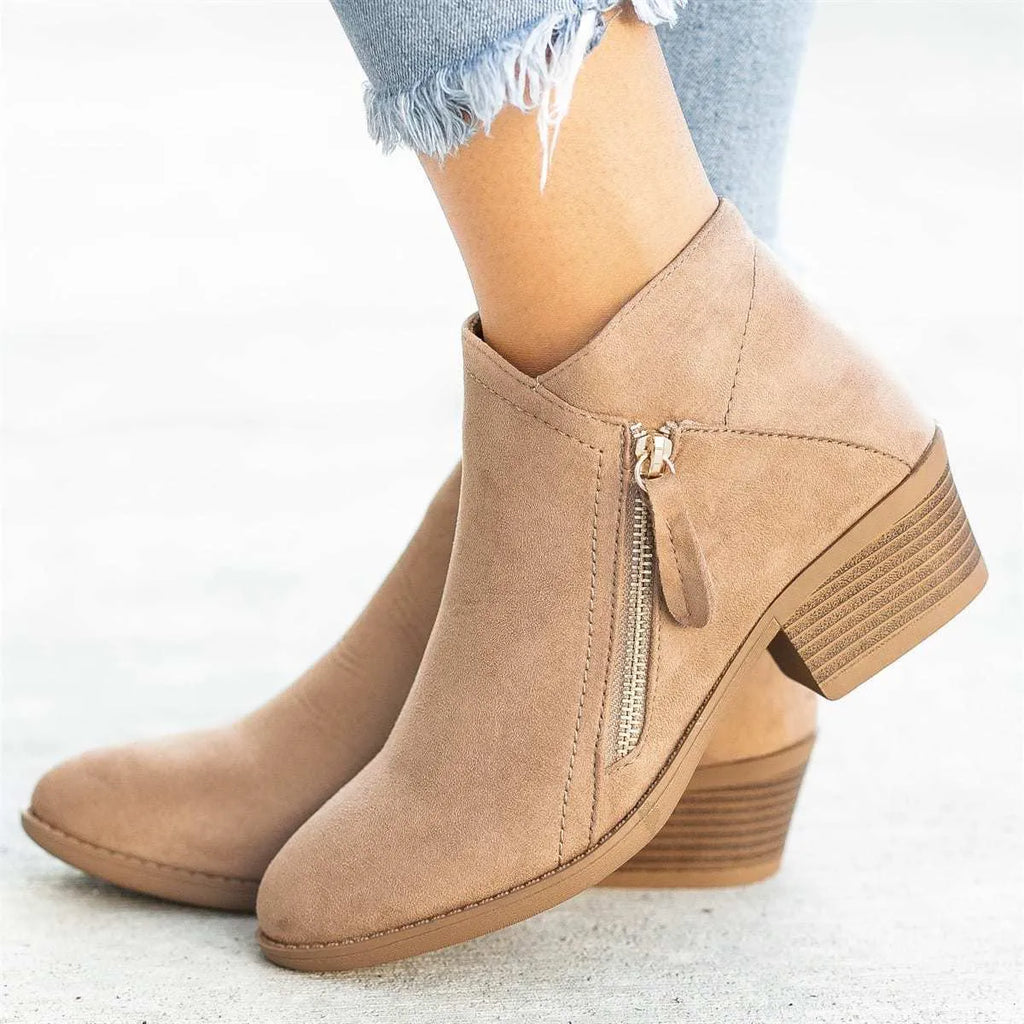 Women's blue suede ankle boots with side zip and chunky heel on wooden floor