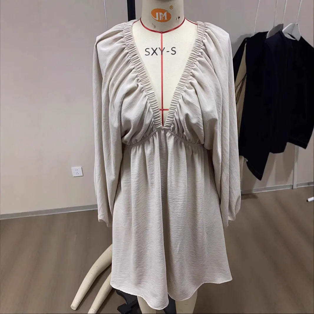 Women's apricot V-neck dress with long puff sleeves and a flounced swing skirt, mid-waist fit.
