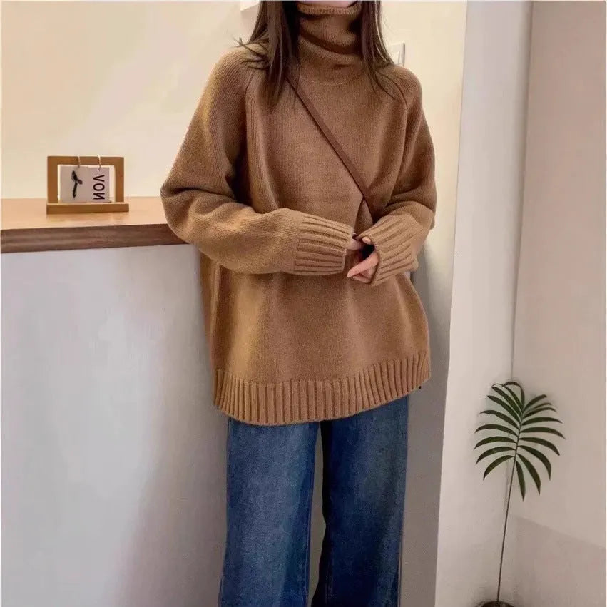 Women's loose grey turtleneck sweater with a textured curling collar and 3D pattern detail.