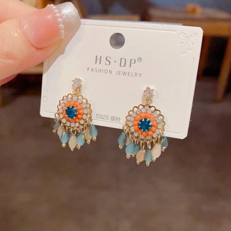 Geometric diamond-embedded crystal tassel earrings in thick gold-plated copper, purple and blue colour options