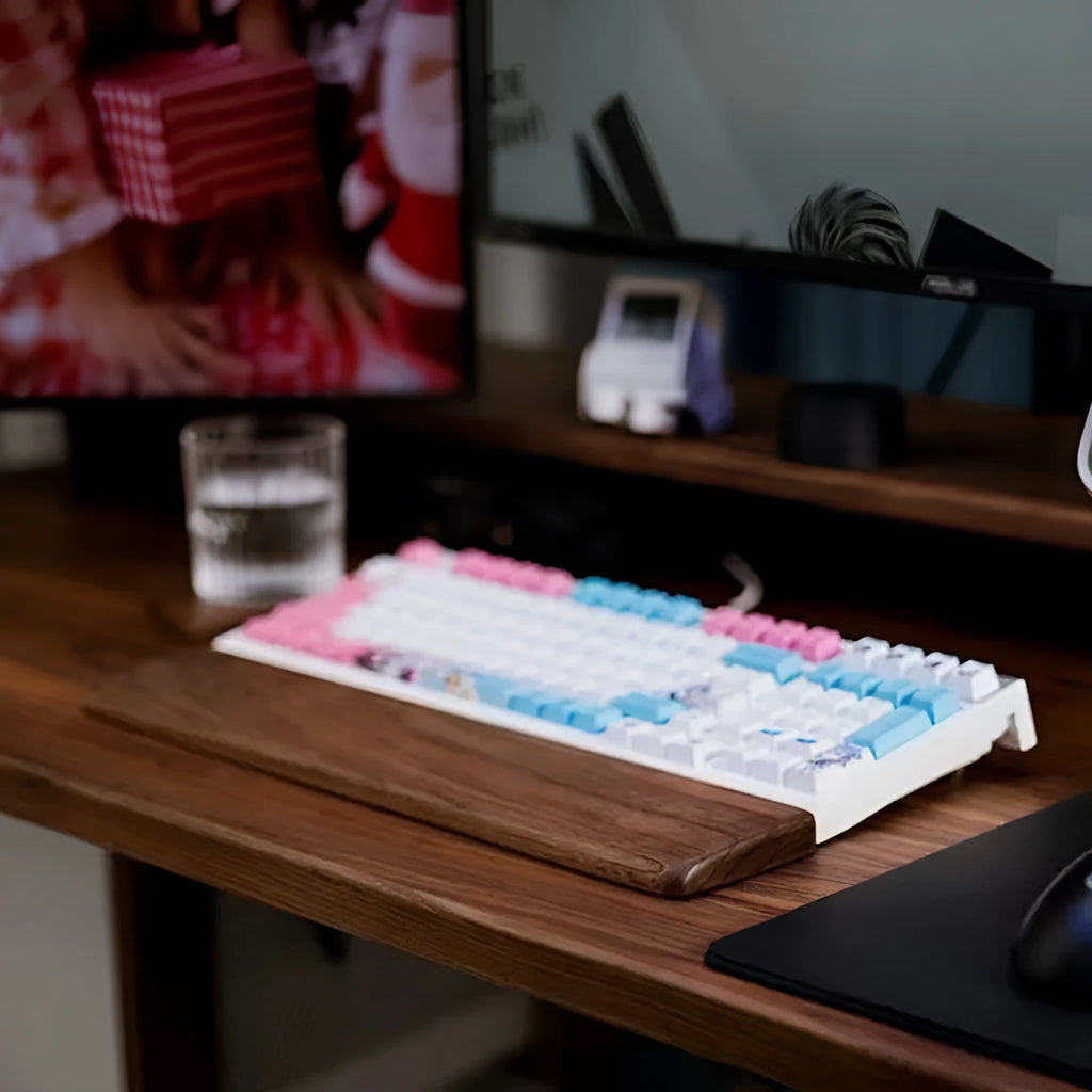 Black walnut wooden keyboard palm rest with wrist strap, 440mm long, on a desk