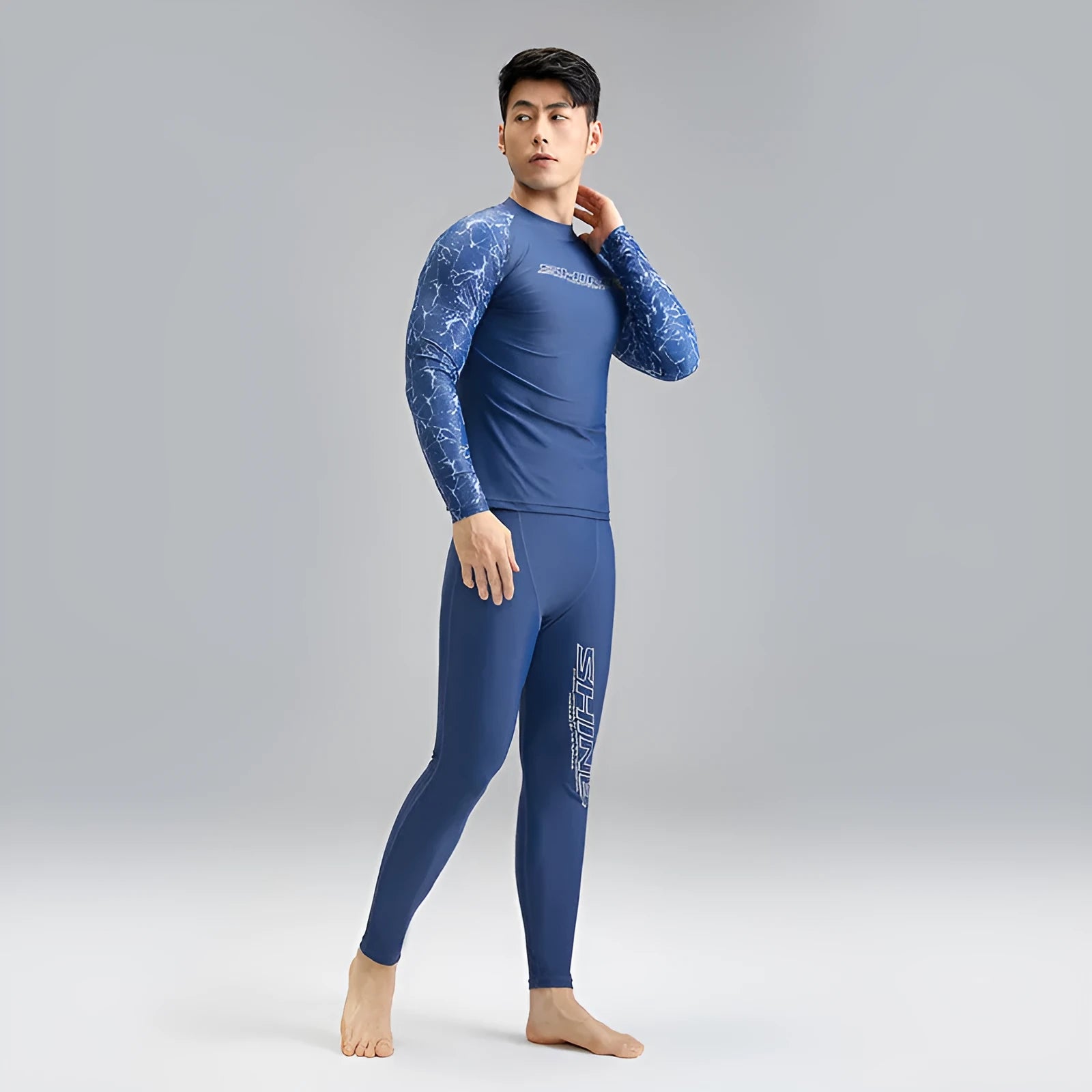 Men's dark blue patterned nylon swimwear set consisting of a top and trousers.