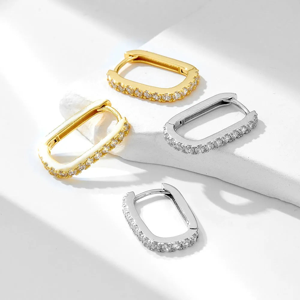 Sterling silver ear clip earrings with oval zircon stones in geometric design