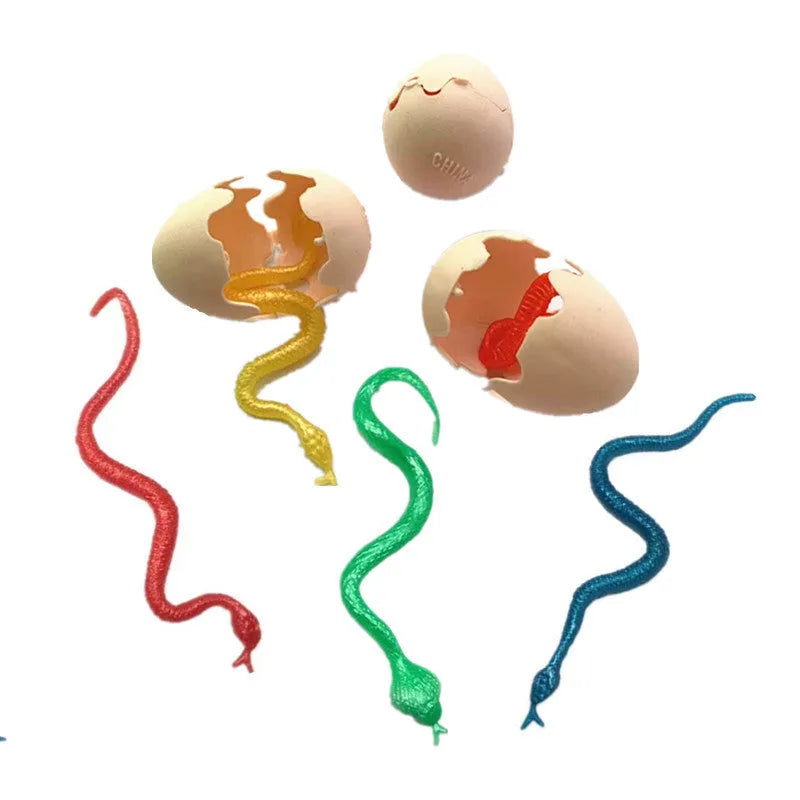 Fake snake egg prank toy with plastic egg shell and stretchable snake on plain background