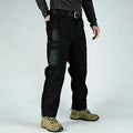 Men's multi-pocket water repellent outdoor trousers in army green, front view showing pockets and fabric texture