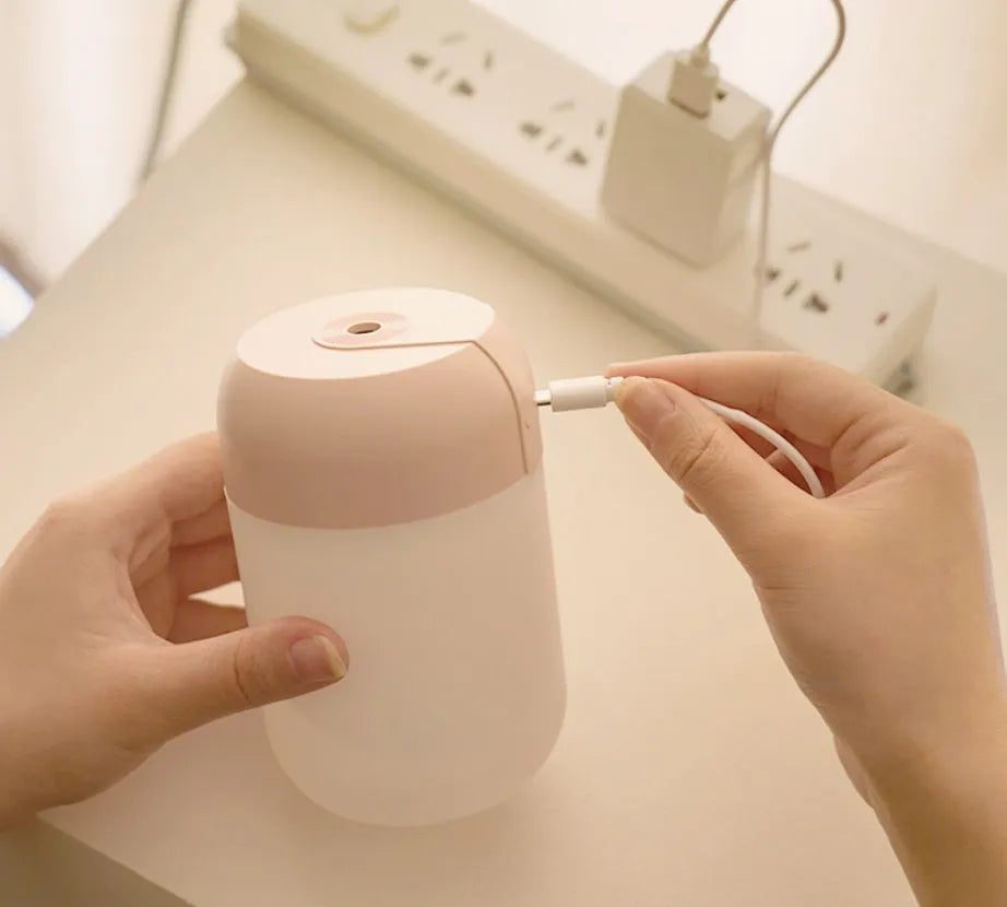 White cylindrical USB mini humidifier with charging cable