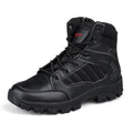 Men's black high-top hiking shoe with metal detail on a rugged outdoor surface