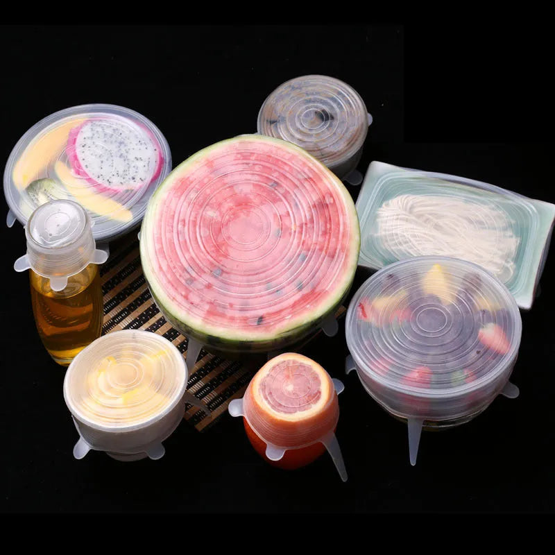 Set of six colourful silicone stretch food covers in different sizes on a kitchen counter.