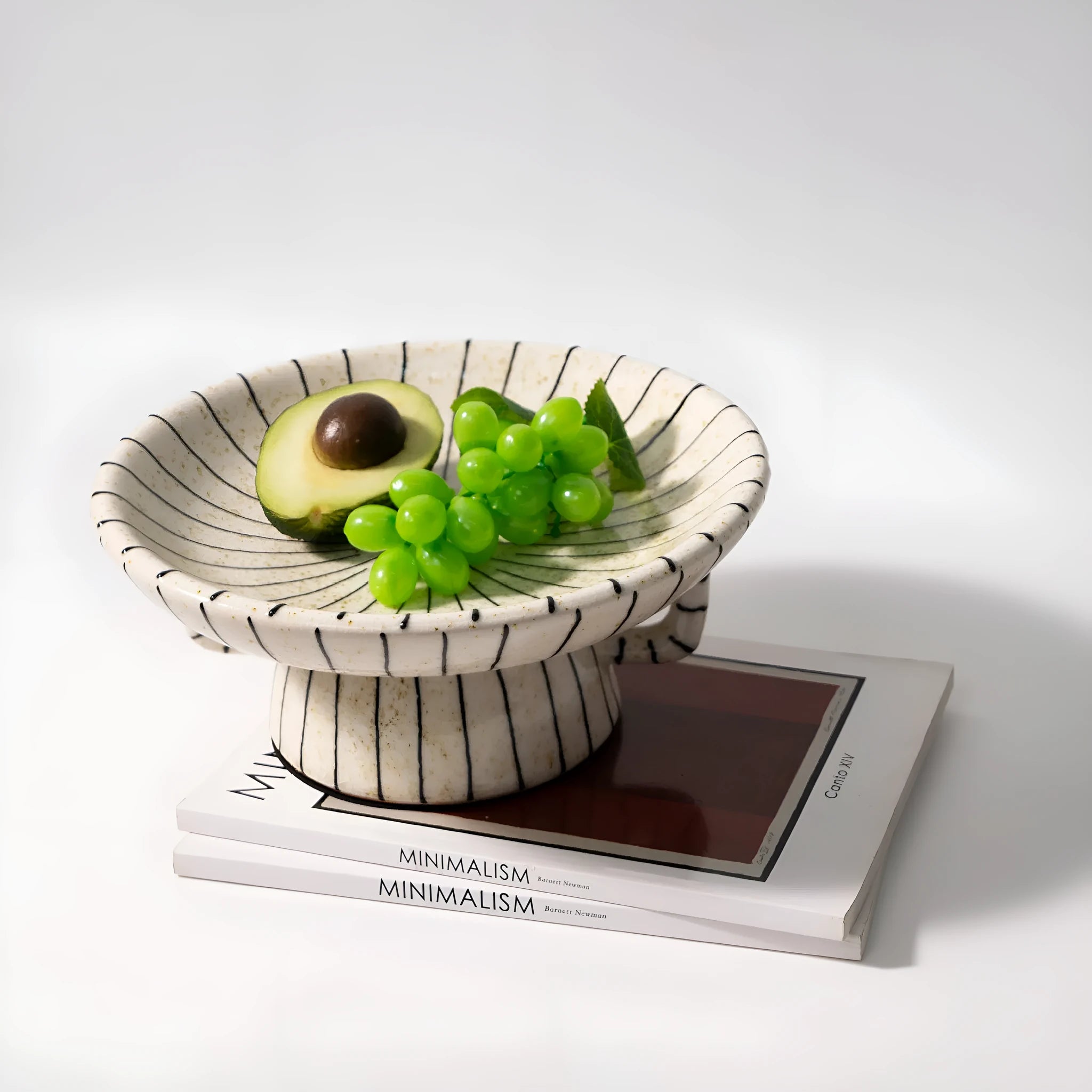Black and white striped synthetic resin fruit plate on a table.