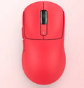 Black rechargeable Bluetooth mouse with USB receiver and coiled parachute cable on a desk.
