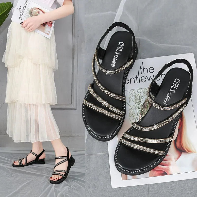 Women's silver flat sandals with rhinestone decoration and elastic band on a rubber sole