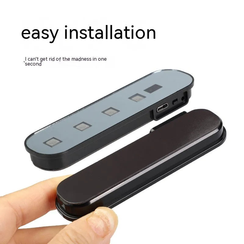 Car door induction lamp with magnetic base showing colourful T-style light projection on ground