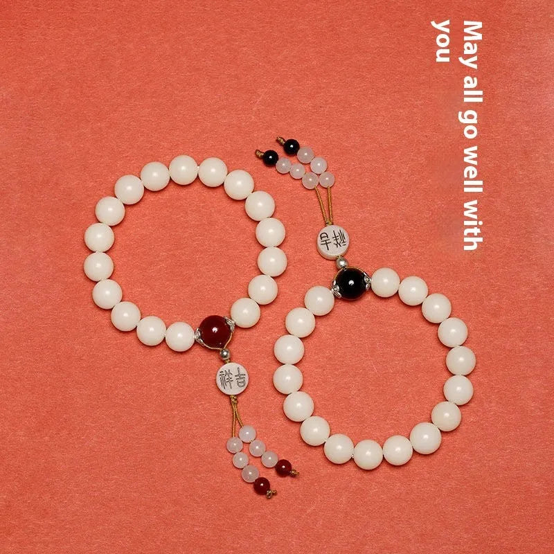 White jade Bodhi couple bracelet with 10mm round seeds in obsidian, red stone, and red code brain colours