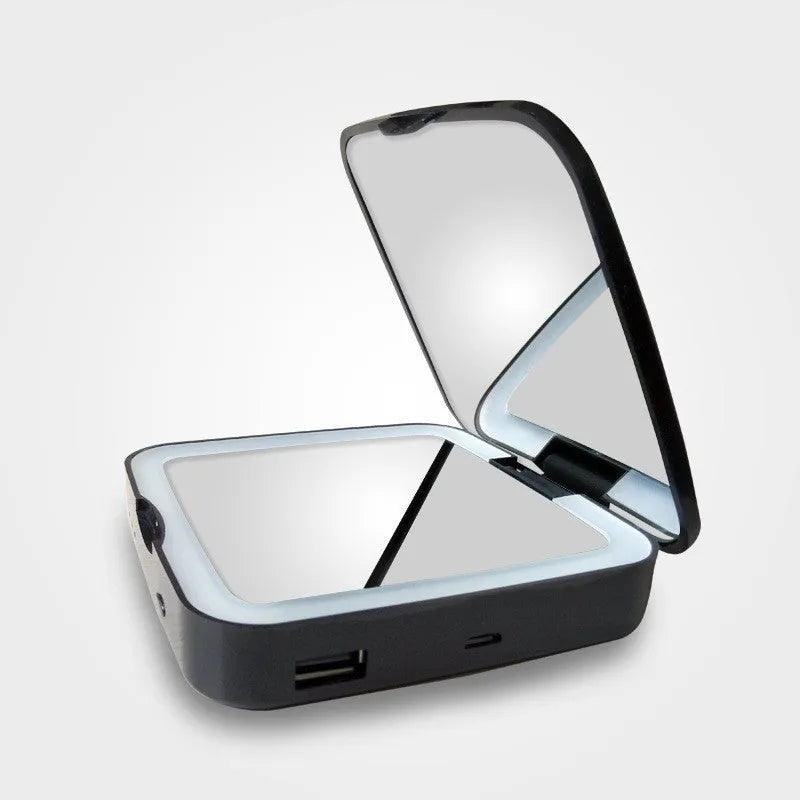 Black and white illuminated vanity mirror showing 4x magnification side and adjustable LED light settings.