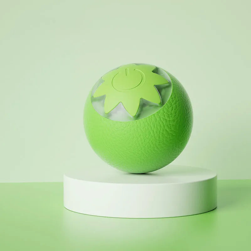 Green electric rolling ball pet toy for dogs and cats on a floor.