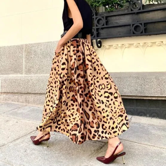 Brown leopard print women's long A-line skirt with a big hem detail on a hanger.