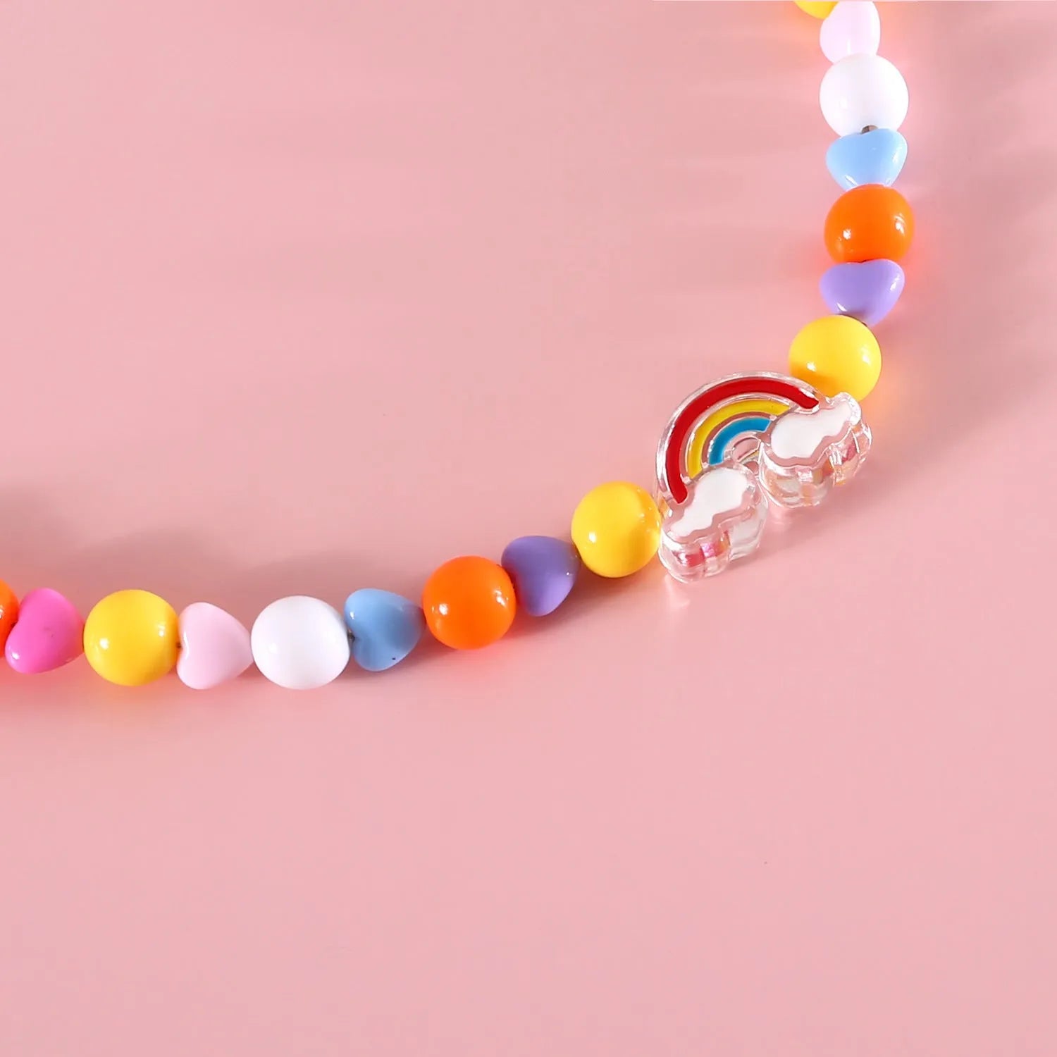 Colourful plastic bead pet necklace for a cat, showing rainbow, peach, and small flower pattern options.