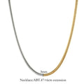 Close-up of a woman's golden 3mm wide snake bones chain necklace with geometric links.