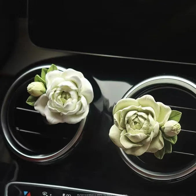 Jasmine-scented gypsum car air freshener ornament in off white or green, shown next to a 5ml essential oil bottle.
