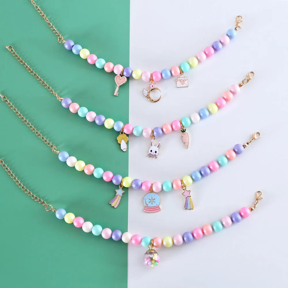 Resin pet headdress and necklace set in macaron colours on a cat or dog, showing moon and crown designs.