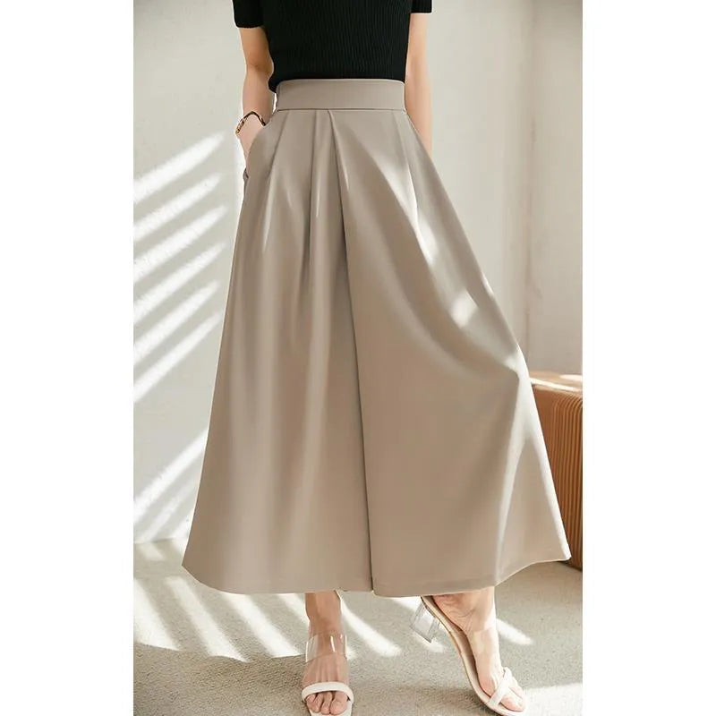 Wide-leg women's trousers in milk apricot with stacked hem design and pockets, flat lay view