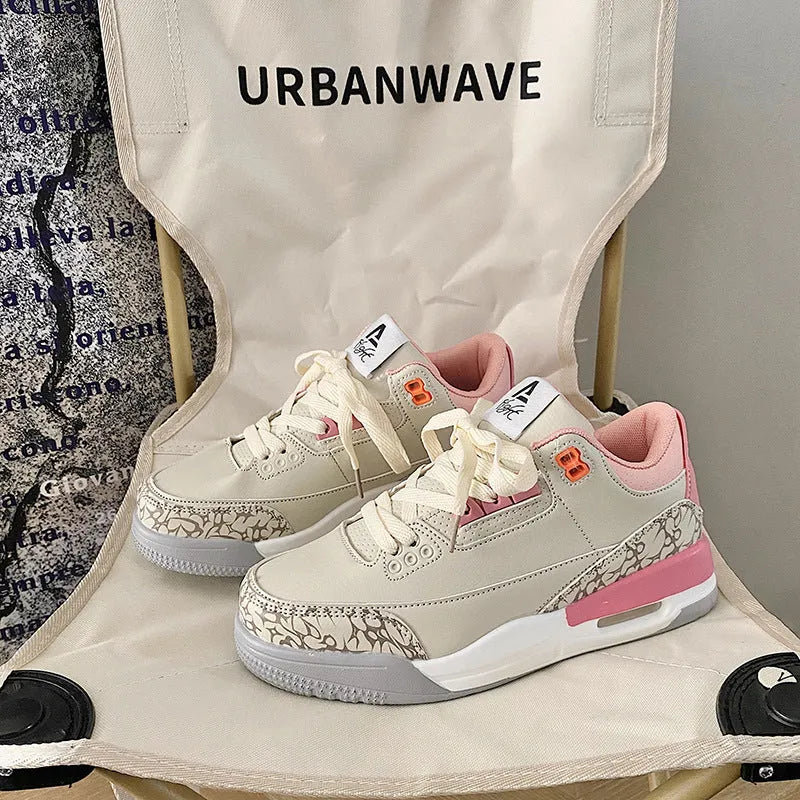 Pink lightweight basketball running shoe with microfiber upper, leather stitching, rubber sole and mesh lining
