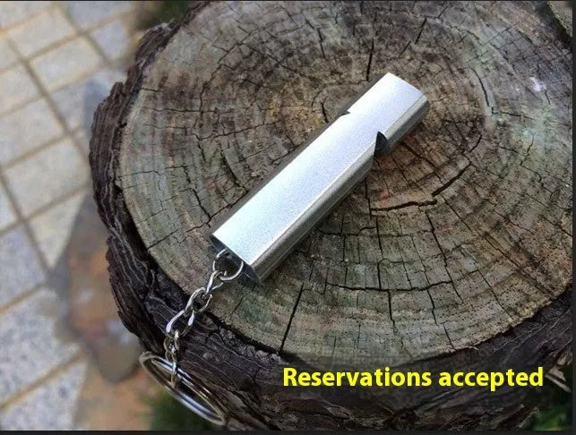 Silver and gold aluminium alloy outdoor survival whistle with double hole design.