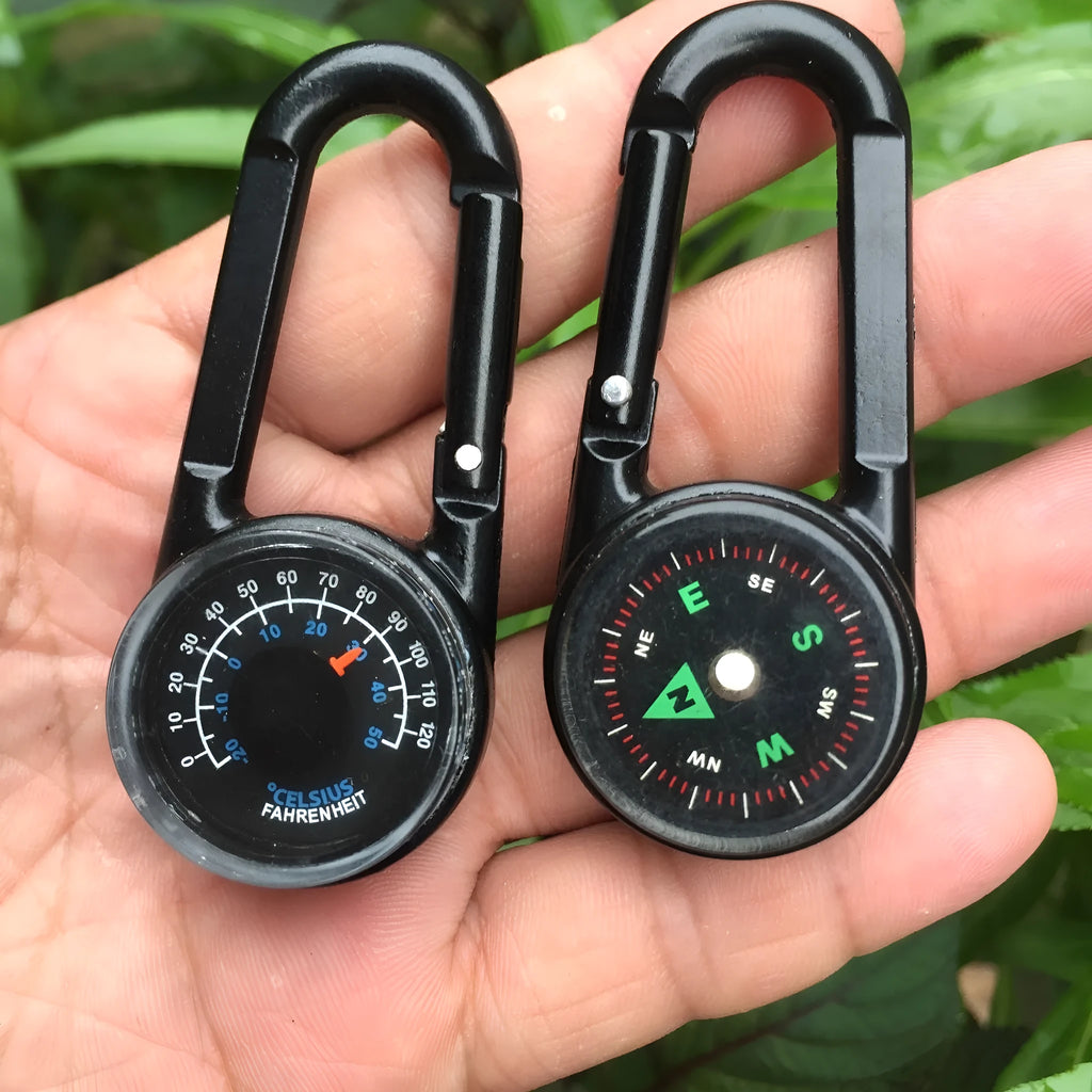 Black zinc alloy camping carabiner with built-in compass and thermometer, showing double-sided button and 65mm size.