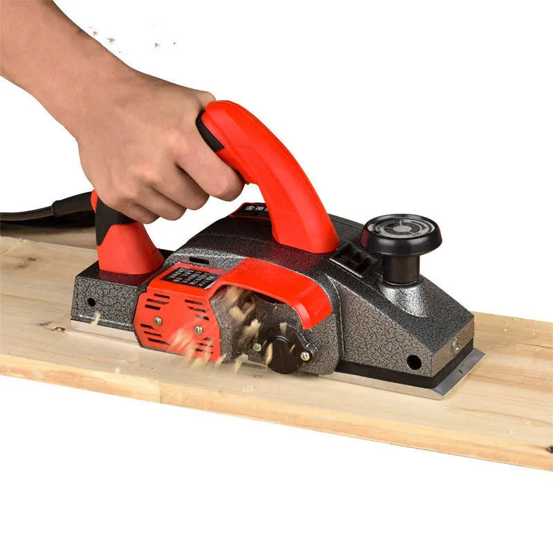 Red electric wood planer with aluminium shell, 82mm planing width