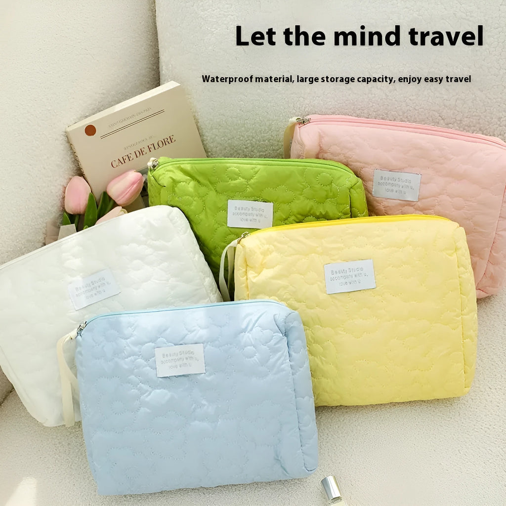Quilted silk cosmetic storage bag in candy colours showing pink, yellow, blue, white, and green options