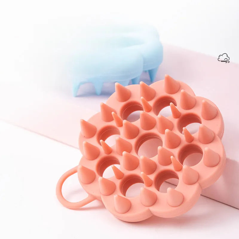 Silicone pet grooming brush with coloured ergonomic handle and flexible massage bristles for dogs and cats.
