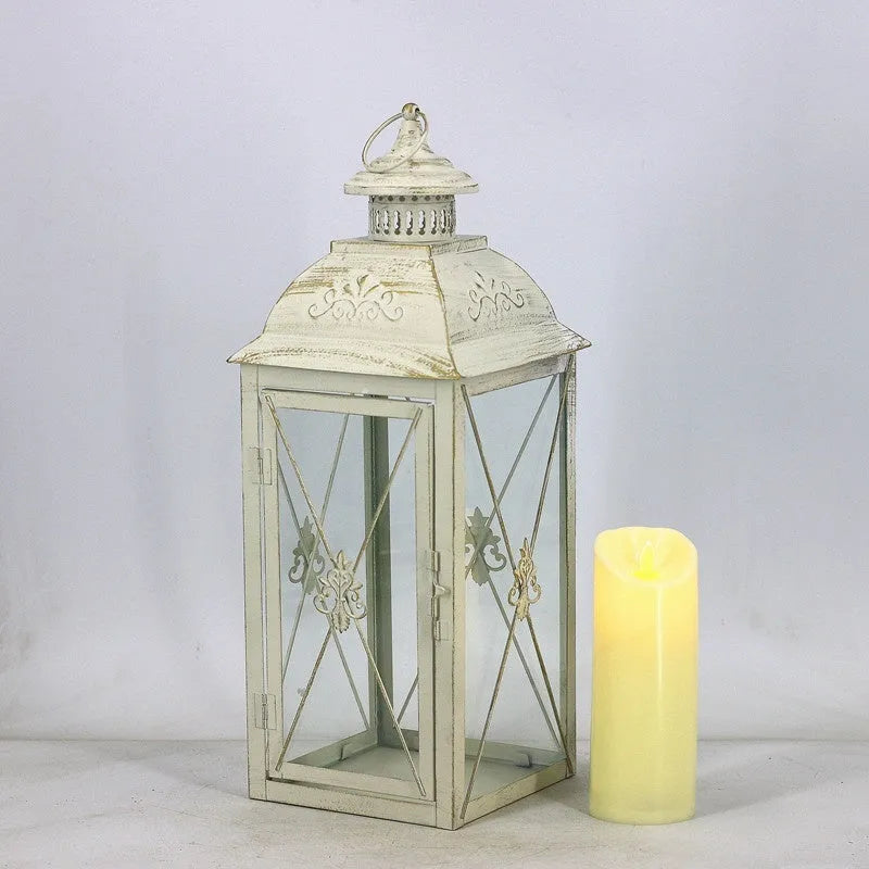 Wrought iron floor-standing storm lantern with tempered glass panels in black gold brushed finish.