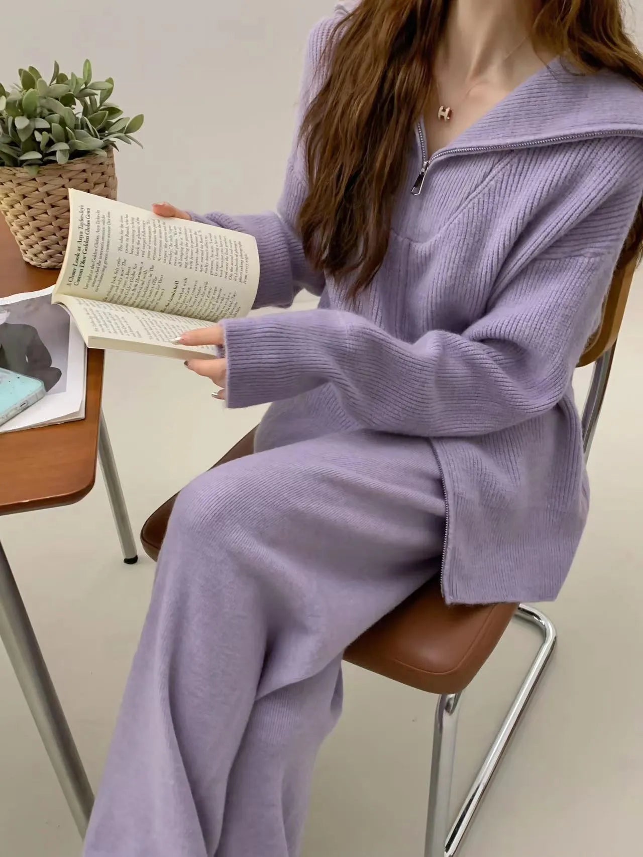 Women's knitted cardigan with zipper and matching wide-leg trouser set in a solid colour.