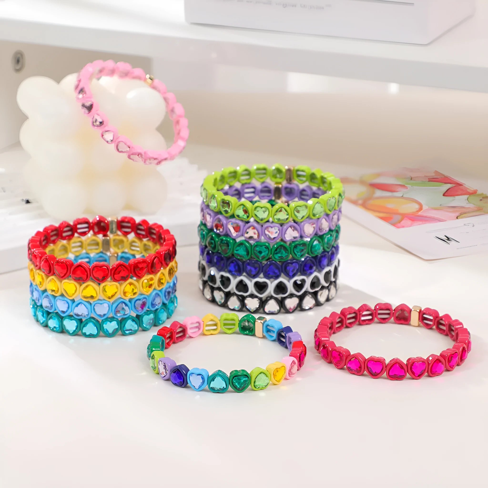Rainbow coloured alloy heart charm on a stretch bracelet with a diamond-effect finish.