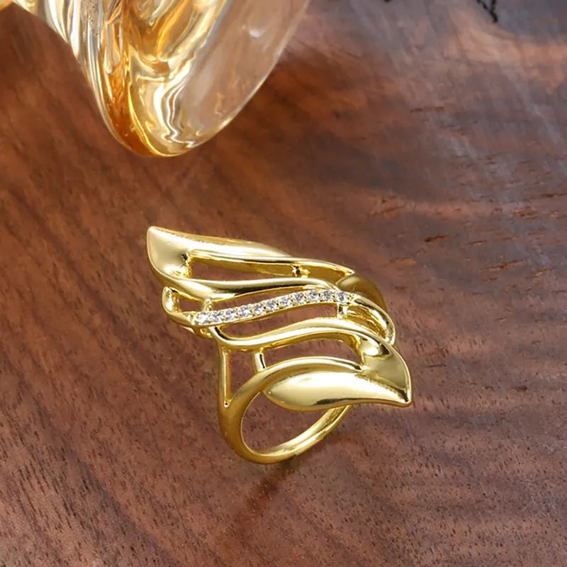Women's copper ring with exaggerated curved design and zircon stone accents in gold colour