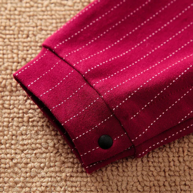 Baby boy wearing a wine red gentleman-style cotton jumpsuit with long sleeves and a single-breasted front.