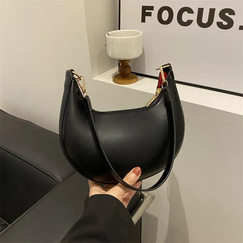 21cm round PU underarm bag with single shoulder strap in seven colour options showing mobile phone pocket