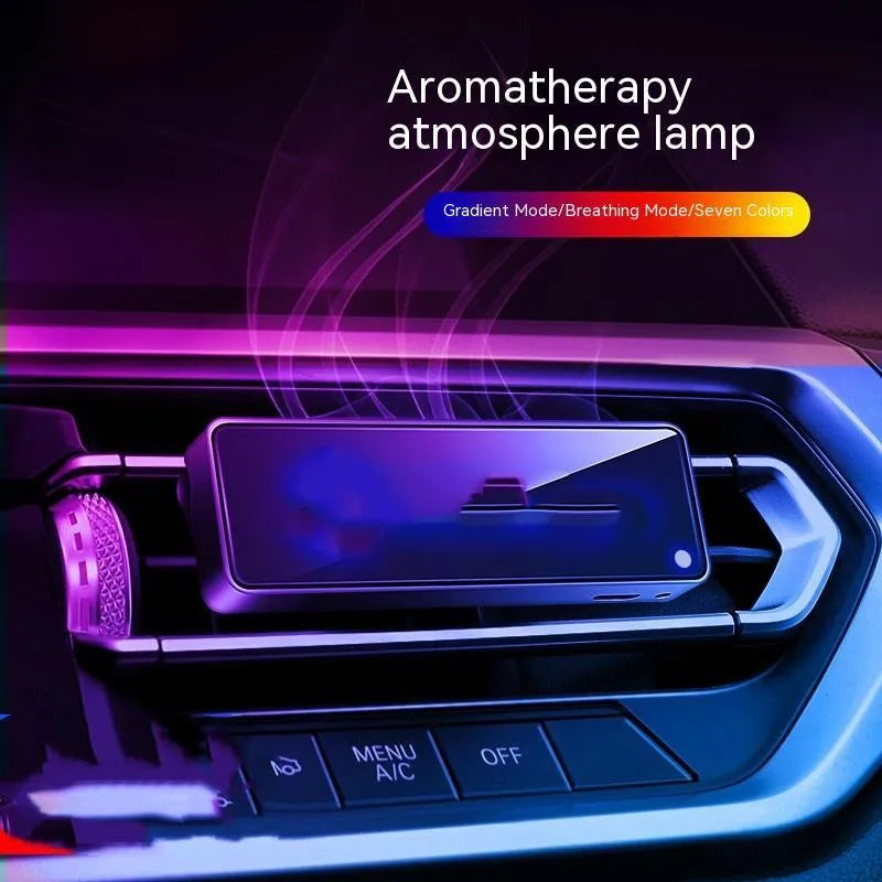 Black car air vent perfume diffuser with LED lighting mounted on vehicle dashboard