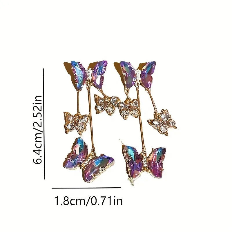 A pair of silver needle crystal flower and butterfly tassel earrings in a blue purple electroplated colour.