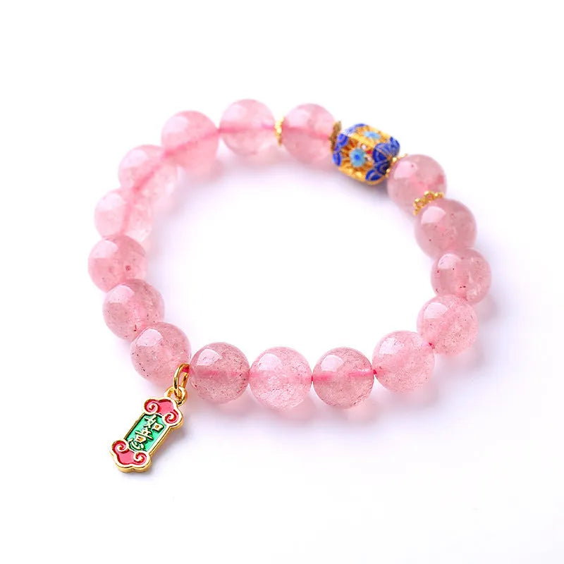 Pink strawberry quartz crystal bracelet with hand-woven beads, Ruyi charm, and letter charms.