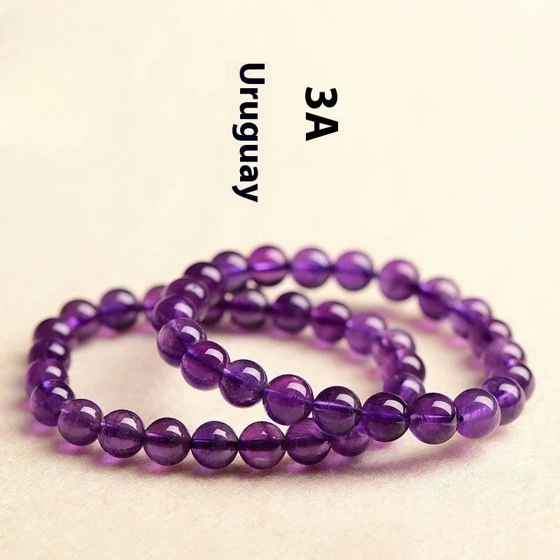 Natural amethyst scattered beads Uruguay bracelet in polished crystal on a white background.