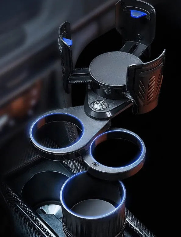 Black adjustable rotating car drink holder with retractable base on a car dashboard.