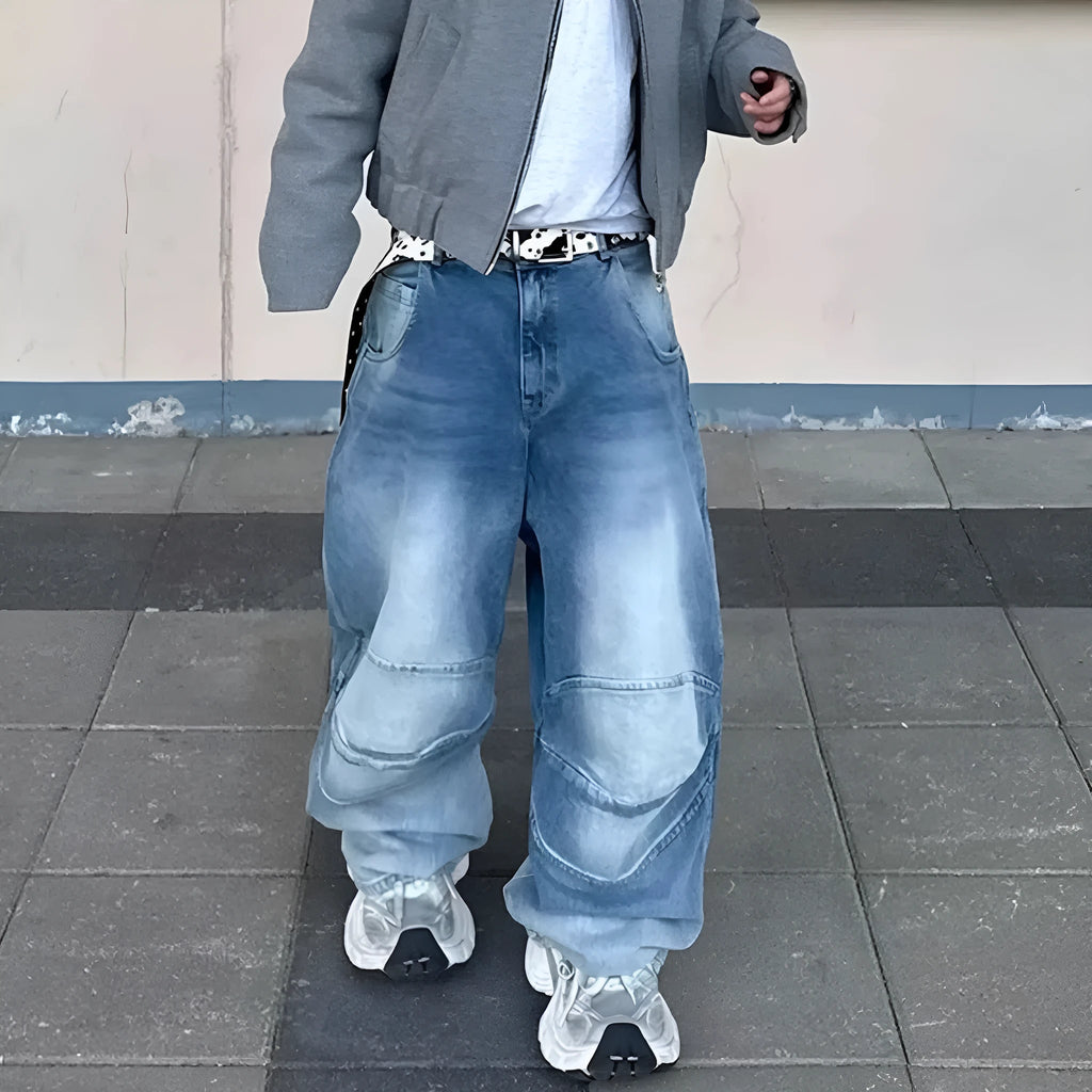 Men's blue white washed denim jeans with baggy cut and straight-leg design showing profile pleating details