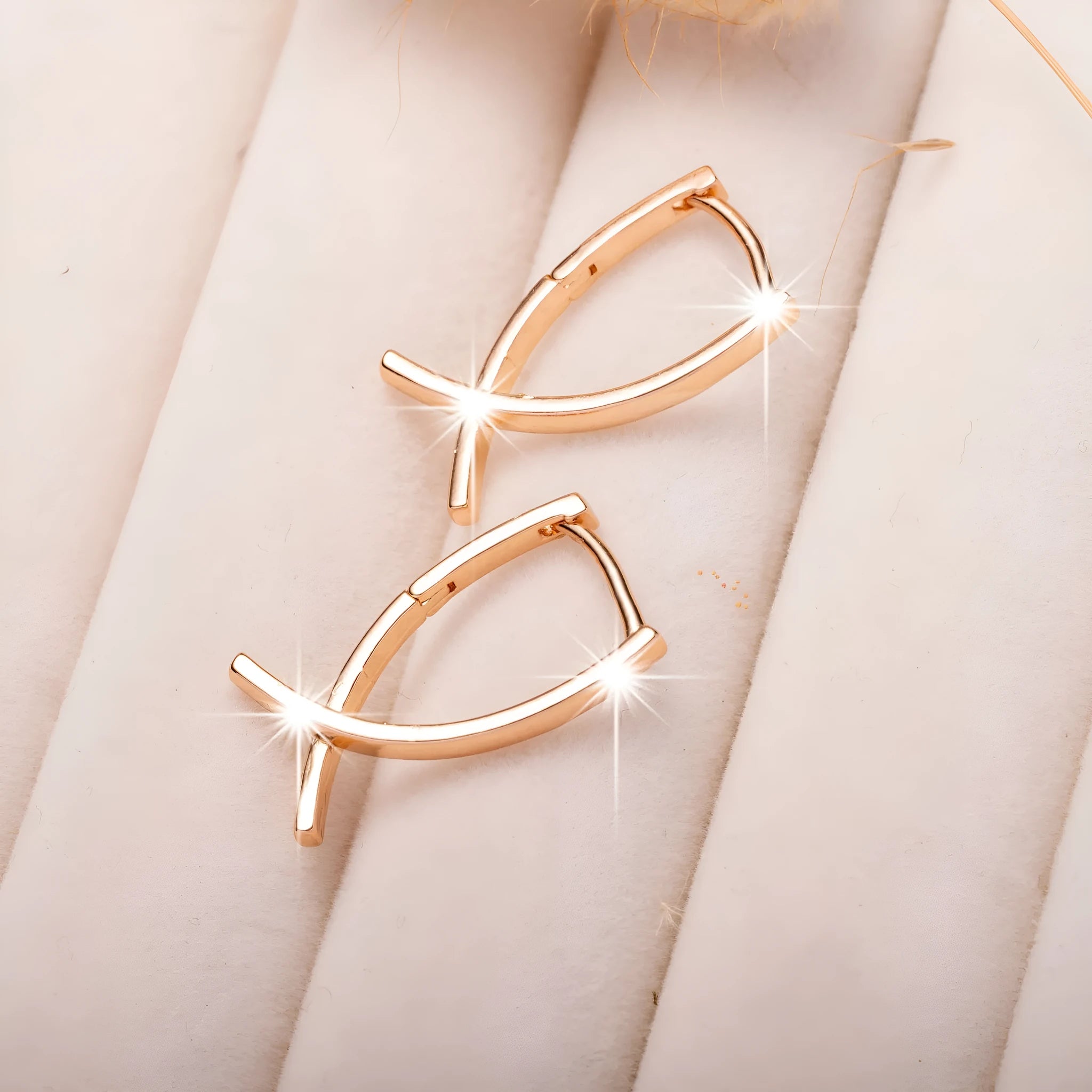 Rose gold coloured cross shaped earrings for women made from copper.