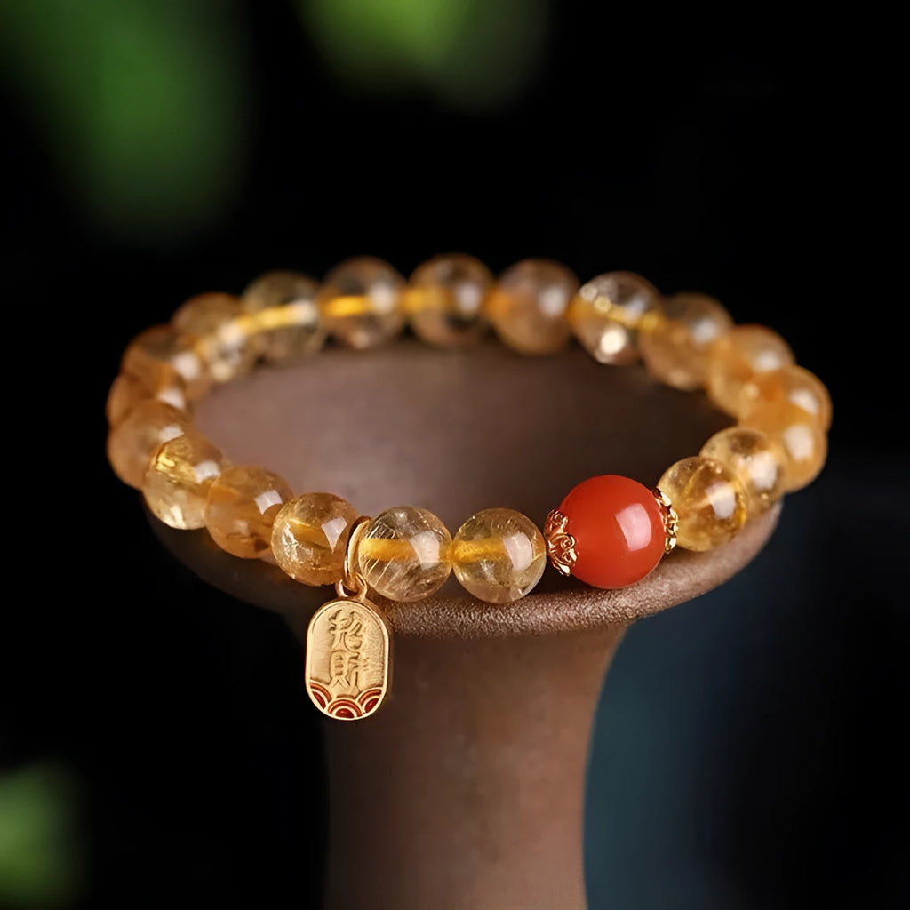 Natural red agate bracelet with gold-tone setting showing polished gemstone beads