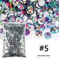 Assortment of multicoloured flat back resin rhinestones in various sizes for nail art and craft projects.