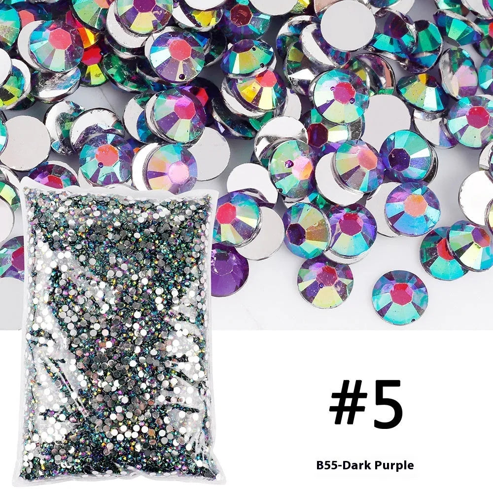 Assortment of multicoloured flat back resin rhinestones in various sizes for nail art and craft projects.
