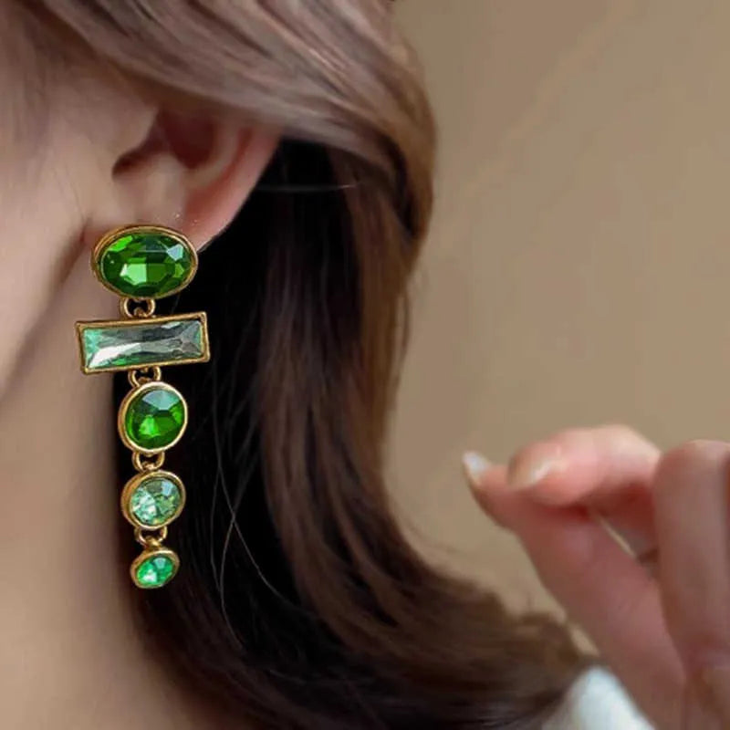 A pair of retro green gradient alloy earrings with geometric Chinese-style design, inlaid zircon stones, and decorative tassels.