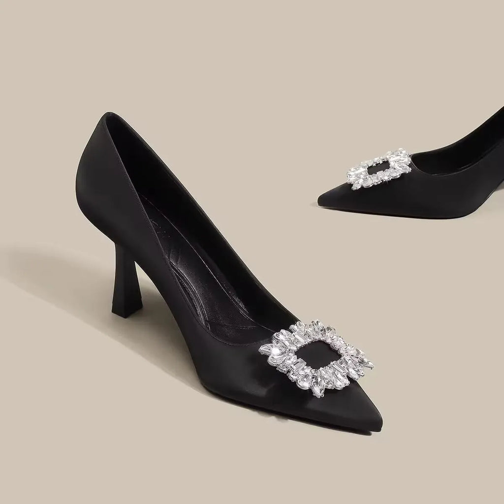 Women's pointed toe stiletto high heels in beige and black, showing low-cut design and thin heel.