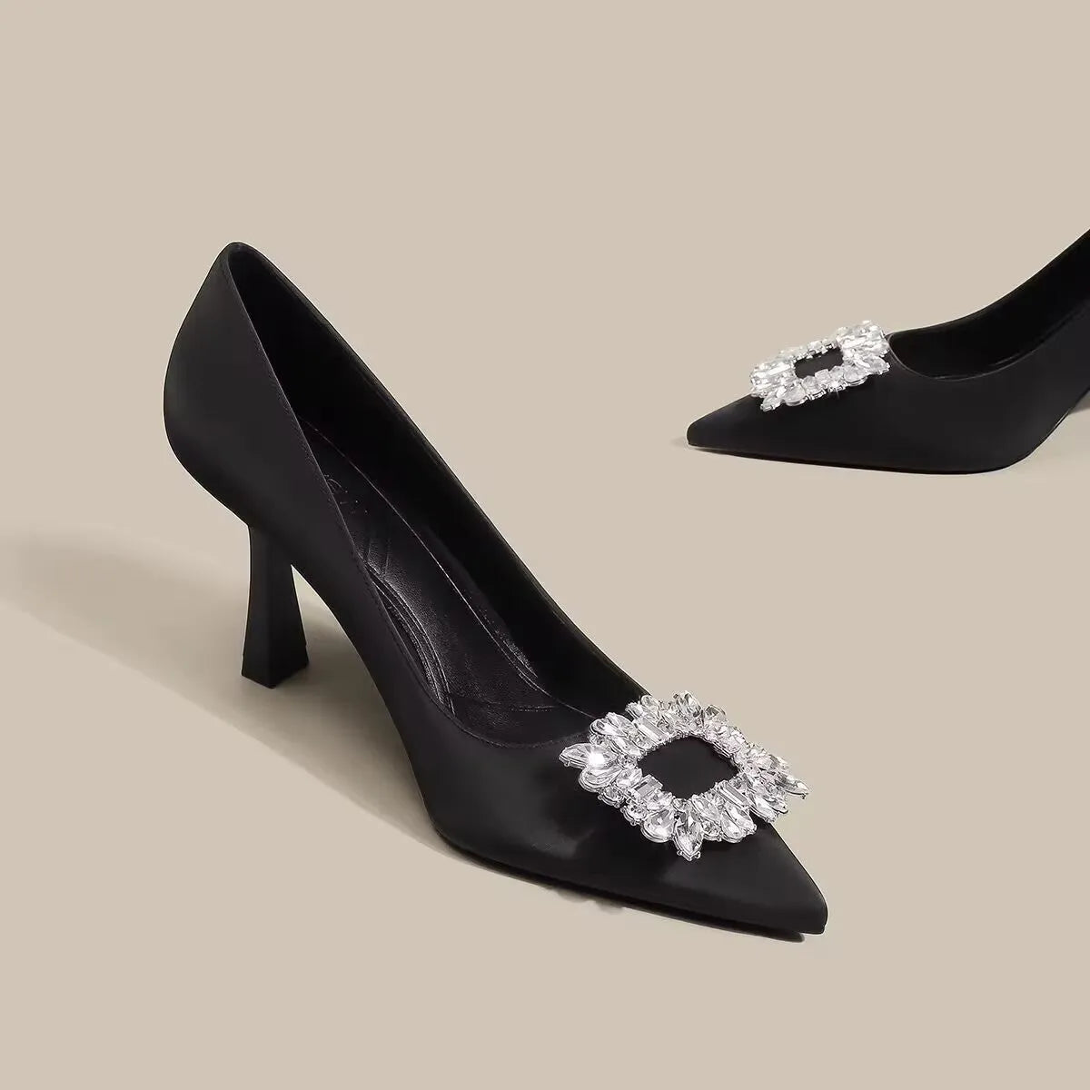 Women's pointed toe stiletto high heels in beige and black, showing low-cut design and thin heel.